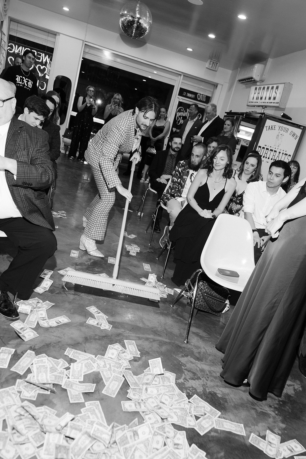 Employee at Sure Thing Chapel sweeping up the dollar bills after a showgirl performance. 