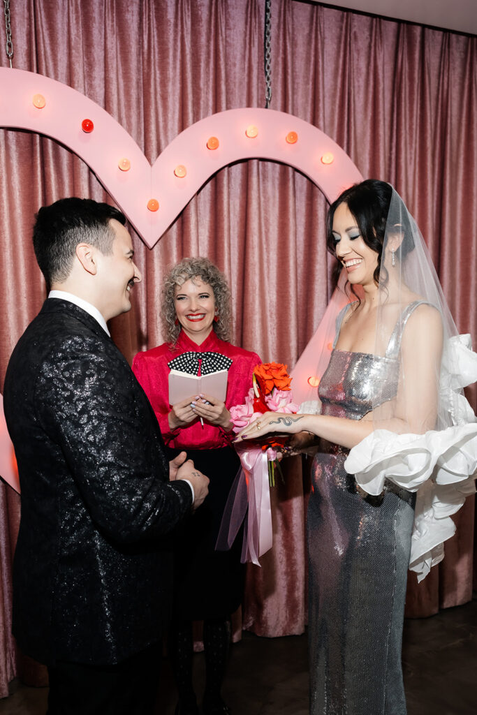 Bride and groom exchanging rings during their Las Vegas micro wedding ceremony at Sure Thing Chapel.