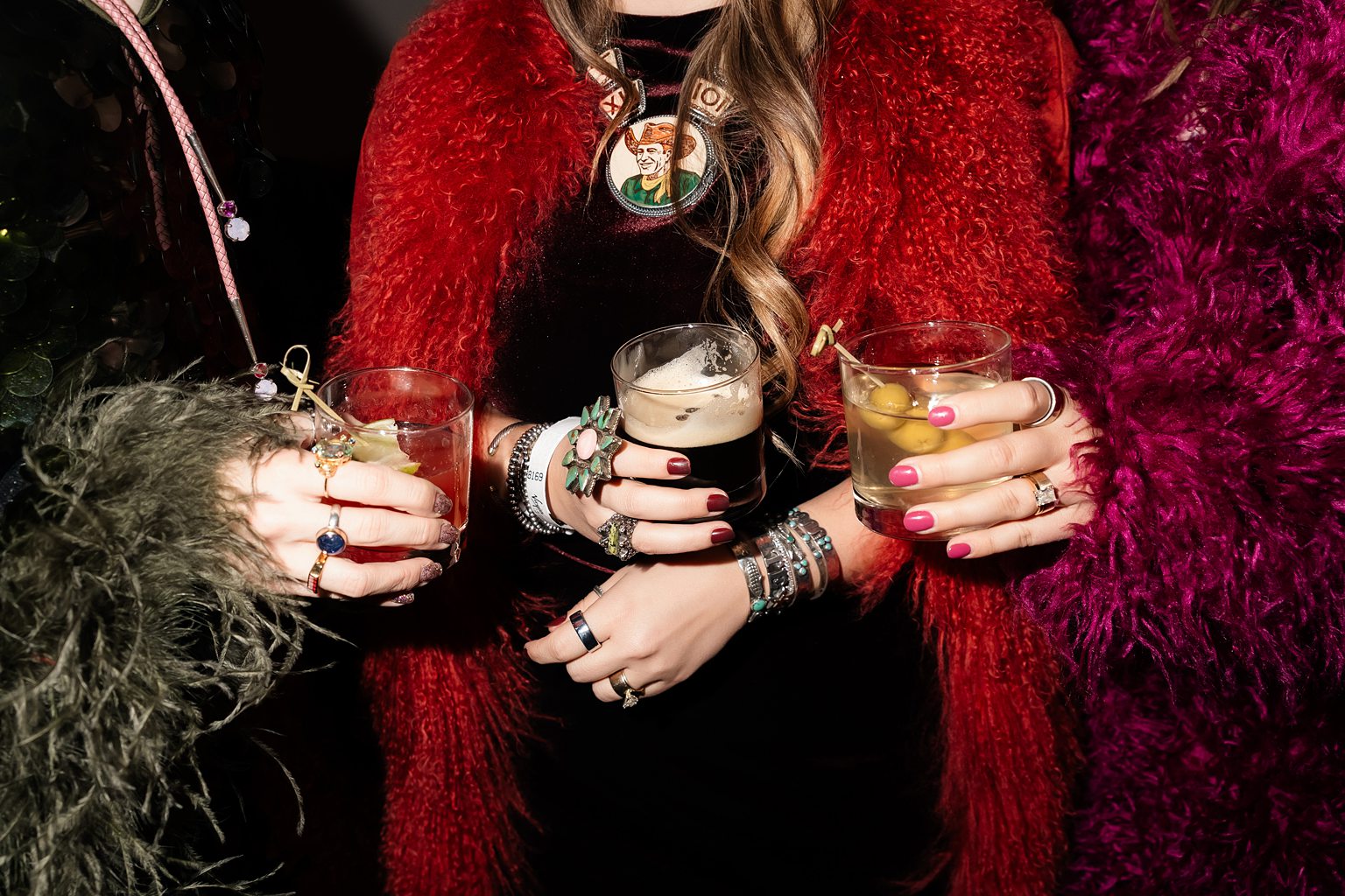 Women holding cocktails in their hands. 