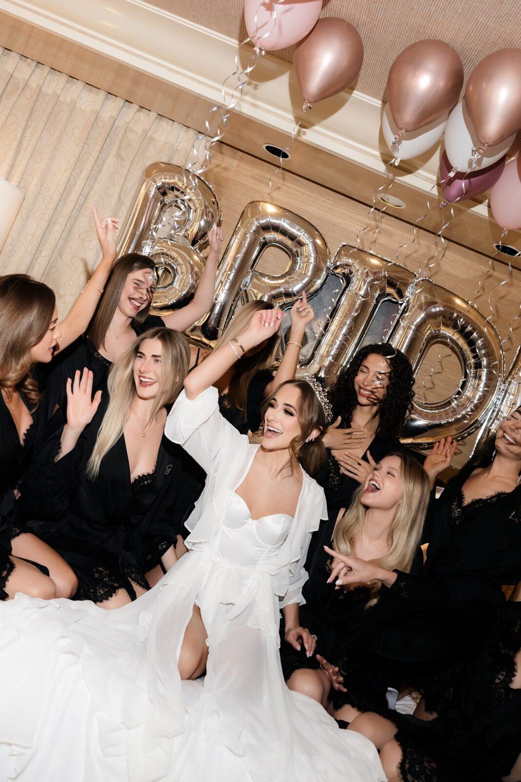 Bride and her friends posing on a bed for their Las Vegas bachelorette party photos. 