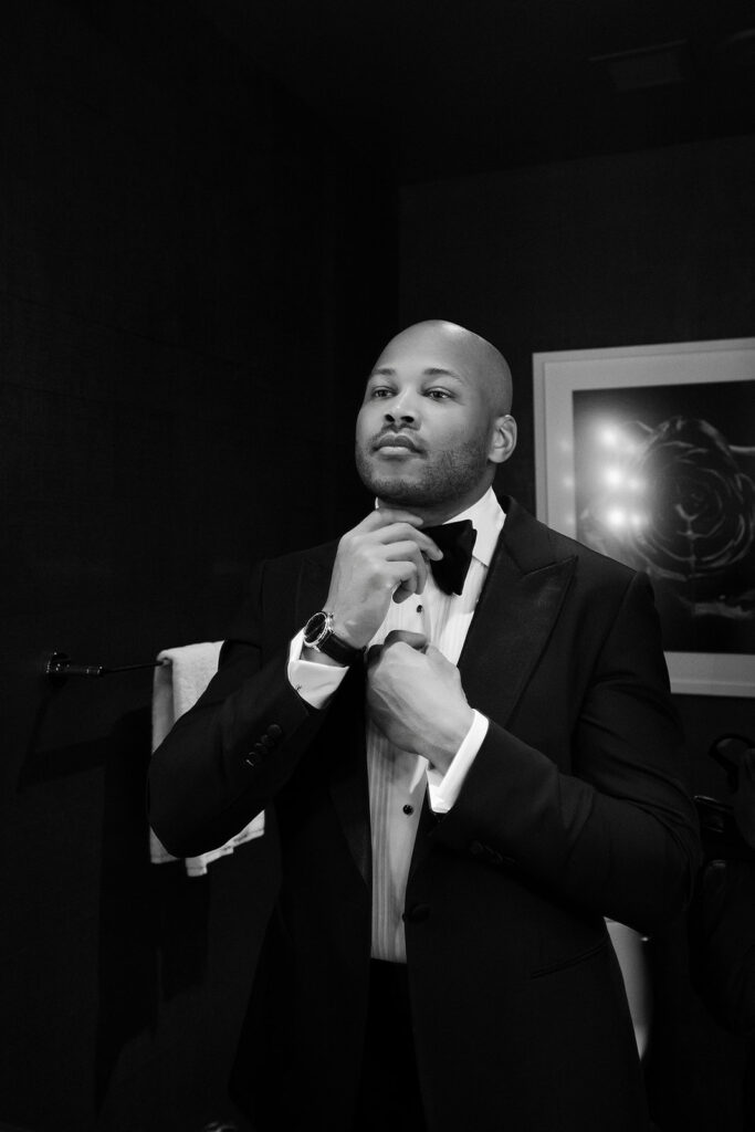 Black and white photo of a groom getting ready for his Wynn Las Vegas wedding.