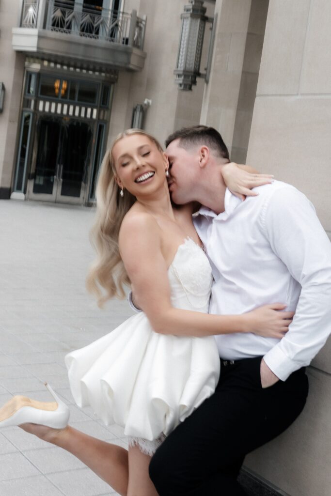 Man kissing his fiancés neck during their engagement session. 