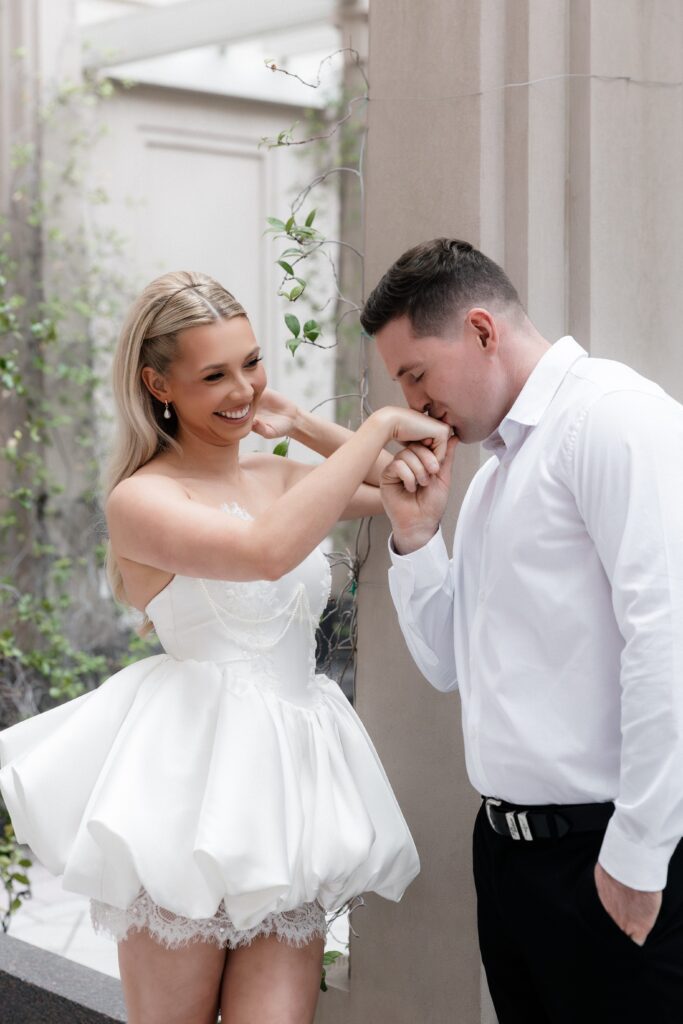 Man kissing his fiancés hand. 