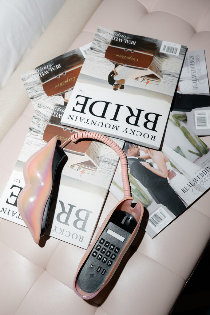 Las Vegas bachelorette party details with pink phone and Rocky Mountain Bride magazines styled in hotel room in Las Vegas.