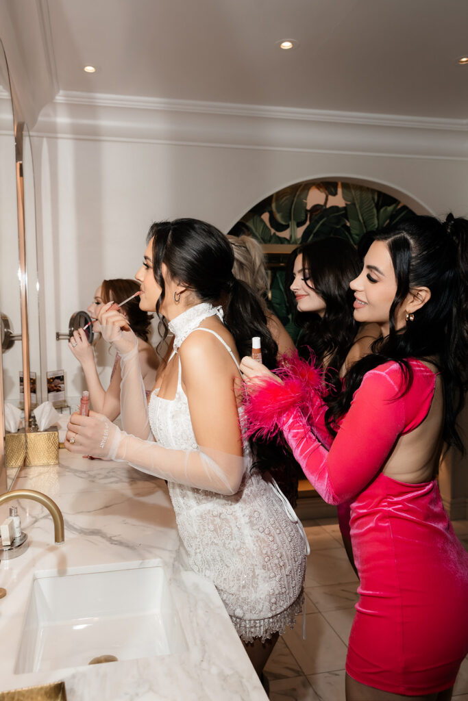 Bride-to-be and friends doing their makeup for Las Vegas bachelorette party photos.