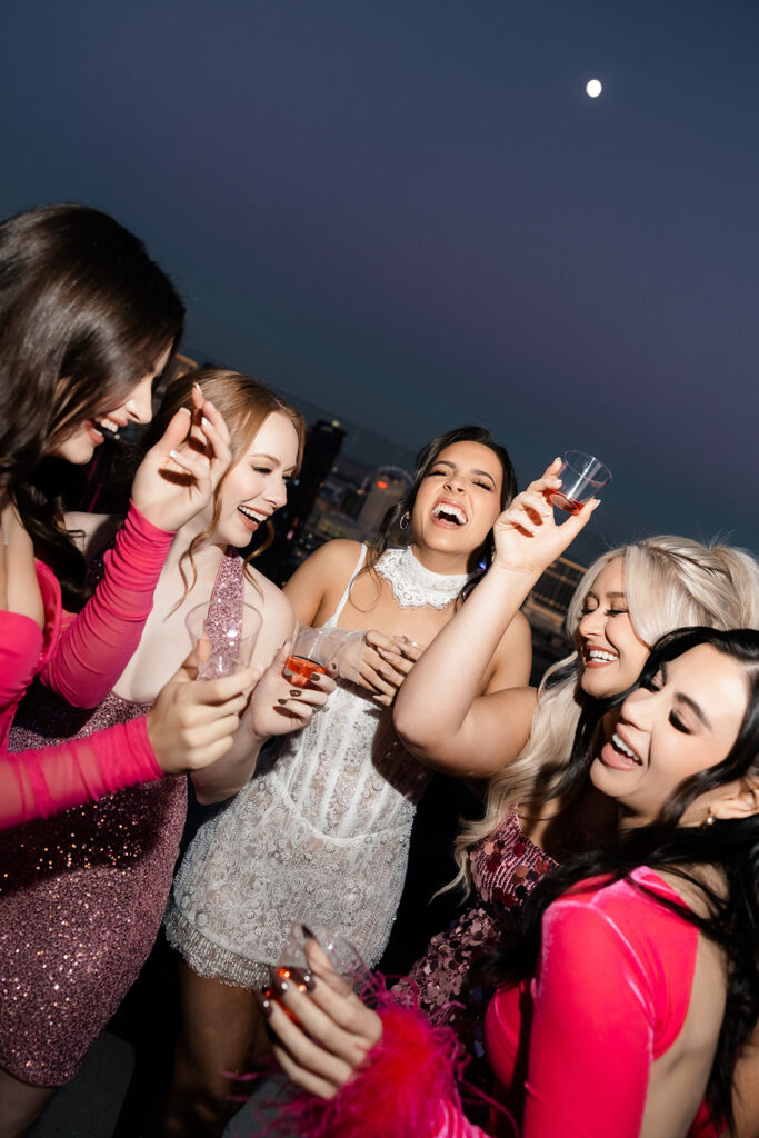 Bride-to-be and friends having drinks on a balcony of their Palms suite in Las Vegas.