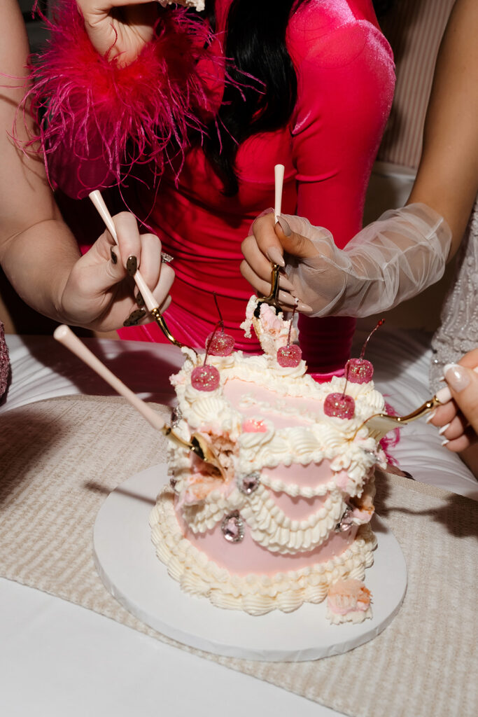 Bride-to-be and friends digging into a cake during a Las Vegas bachelorette party photoshoot.
