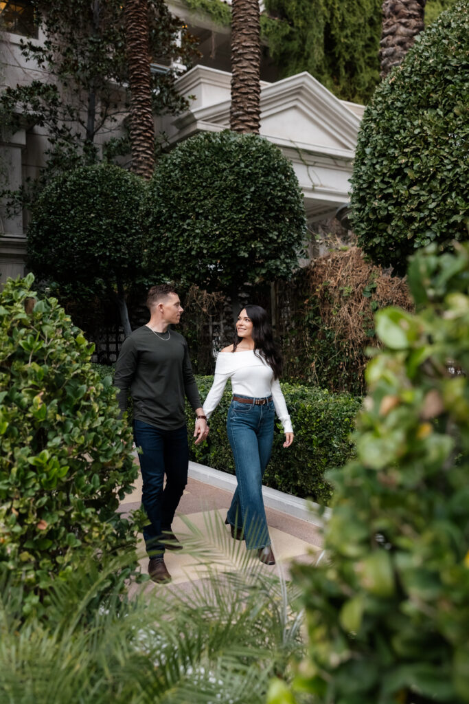 Couple walking together outside of Caesars Palace for their Las Vegas engagement photos.