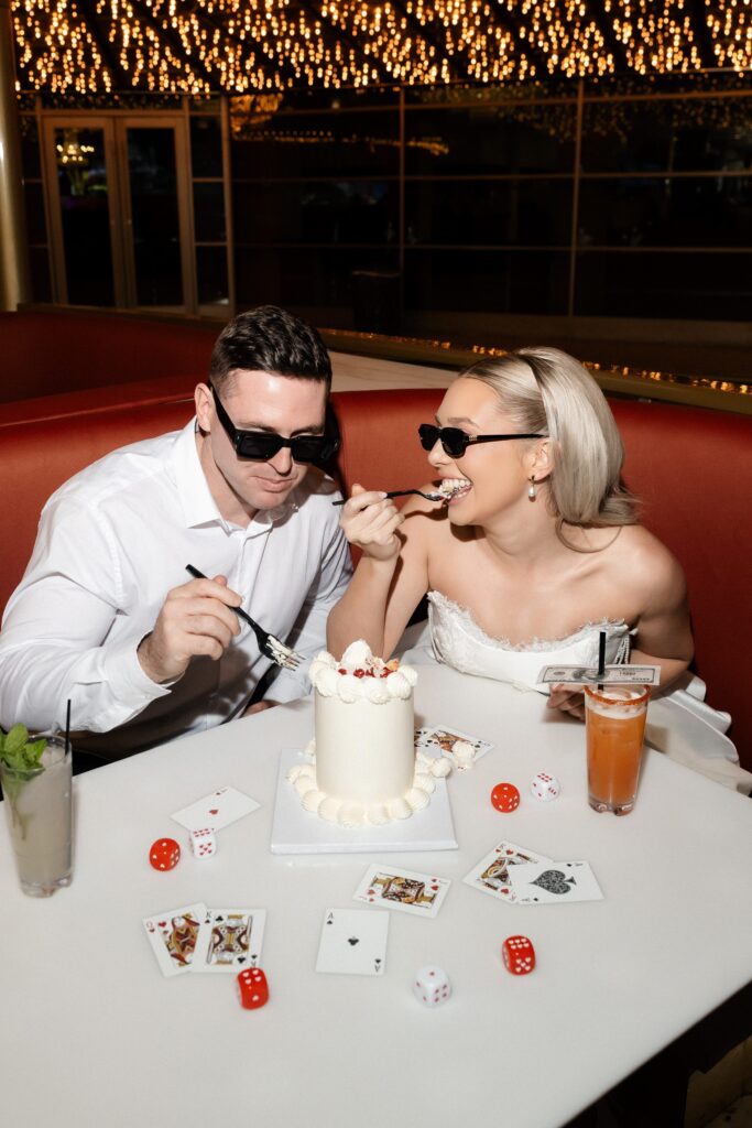 Couple digging into their cake during their Las Vegas engagement shoot.