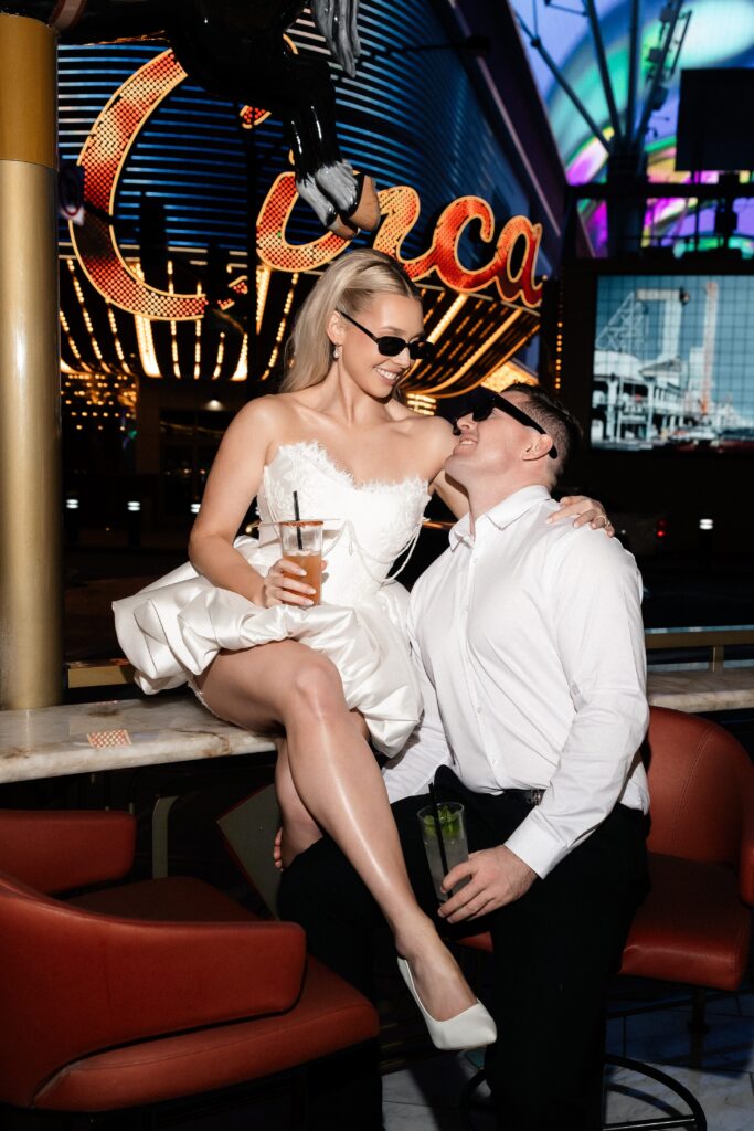 Couple having drinks at Carousel Bar for their Las Vegas engagement session.
