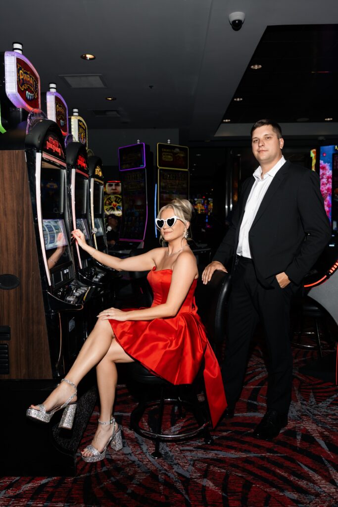Couple playing the slots for their Las Vegas engagement photos. 