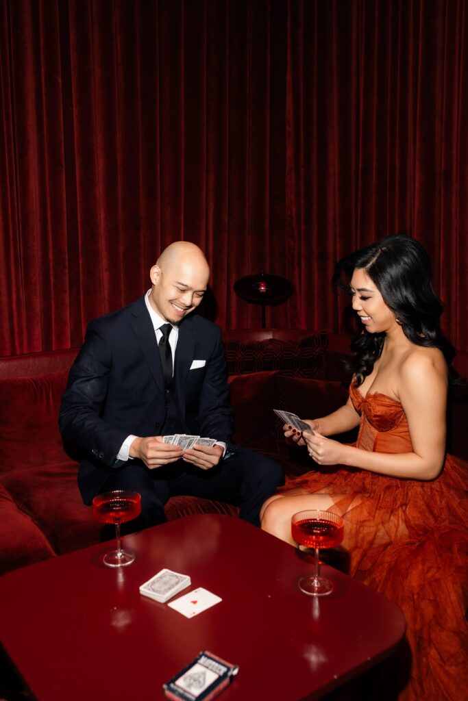 Couple playing cards at Wax Rabbit for their Las Vegas engagement photos.