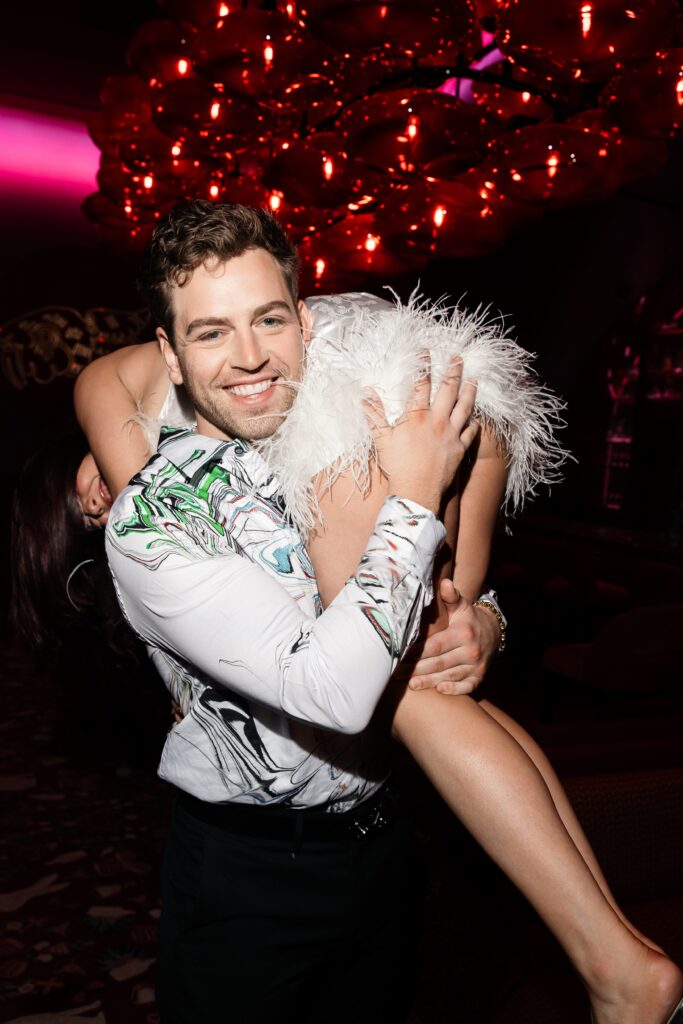 Man carrying his fiancé on his shoulders.