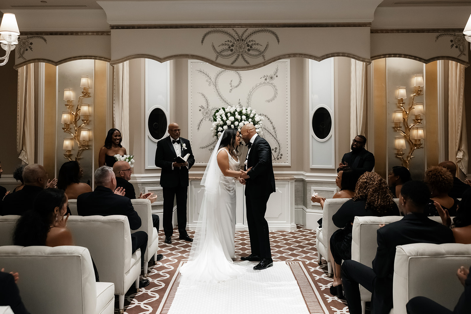 Bride and groom touching foreheads and sharing a moment at the end of the Wynn Las Vegas wedding ceremony in the Lavender Salon.