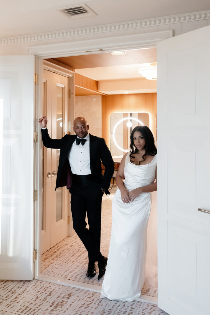 Bride and groom posing in their suite at Wynn Las Vegas.