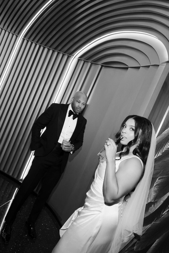 Black and white editorial wedding photo of a bride and groom sipping cocktails during their Wynn Las Vegas wedding. 