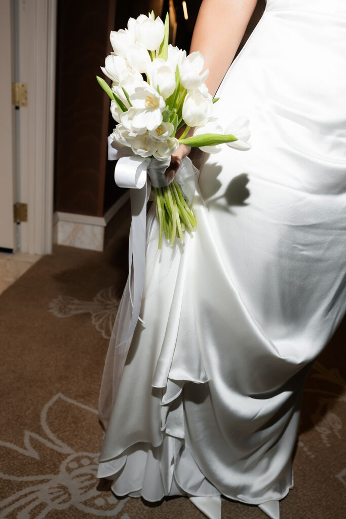 Close up flash photo of a bride holding her wedding bouquet. 