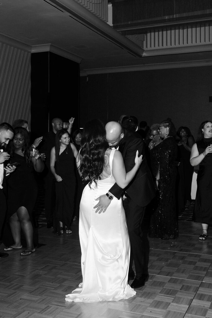 Black and white photo of a bride and groom dancing during a Wynn Las Vegas wedding reception. 