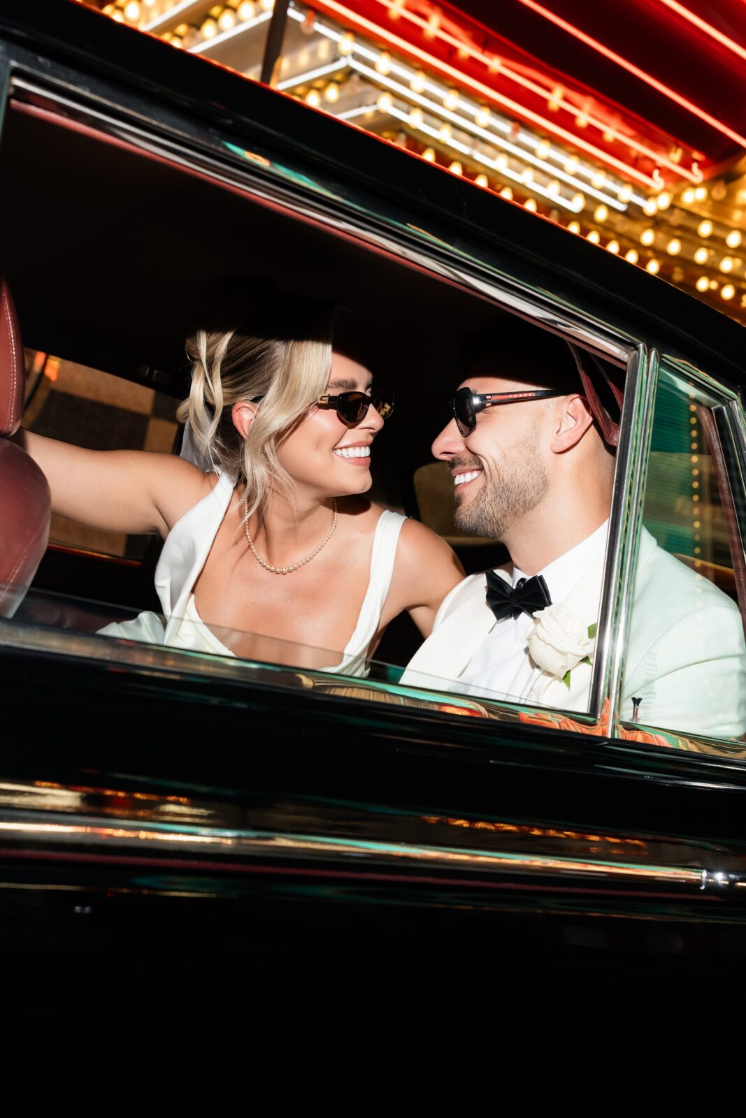 Bride and groom posing in their limo during their luxury elopement in Las Vegas. 
