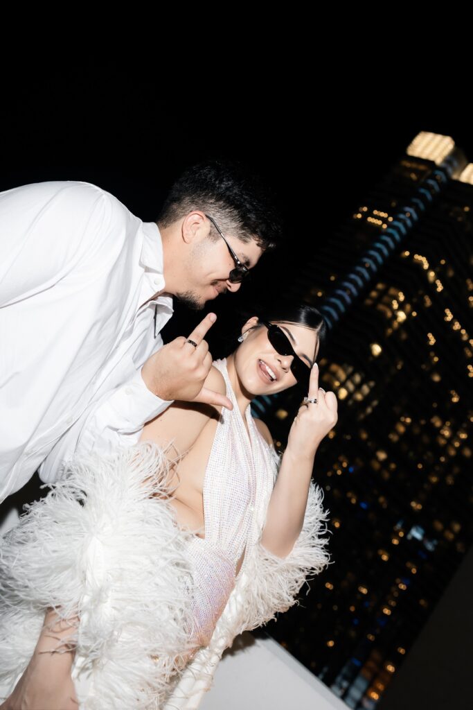 Bride and groom posing with the city behind them for their luxury elopement photos in Las Vegas.