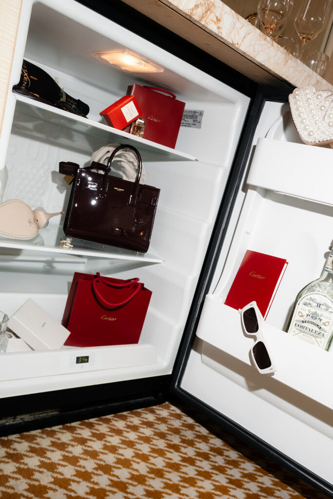 Designer accessories and luxury items displayed in a hotel mini fridge during a Las Vegas luxury elopement.