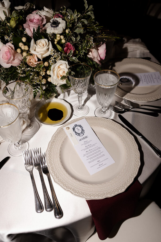 Elegant reception table setting with floral centerpiece and menu at the Canaletto Las Vegas wedding reception.
