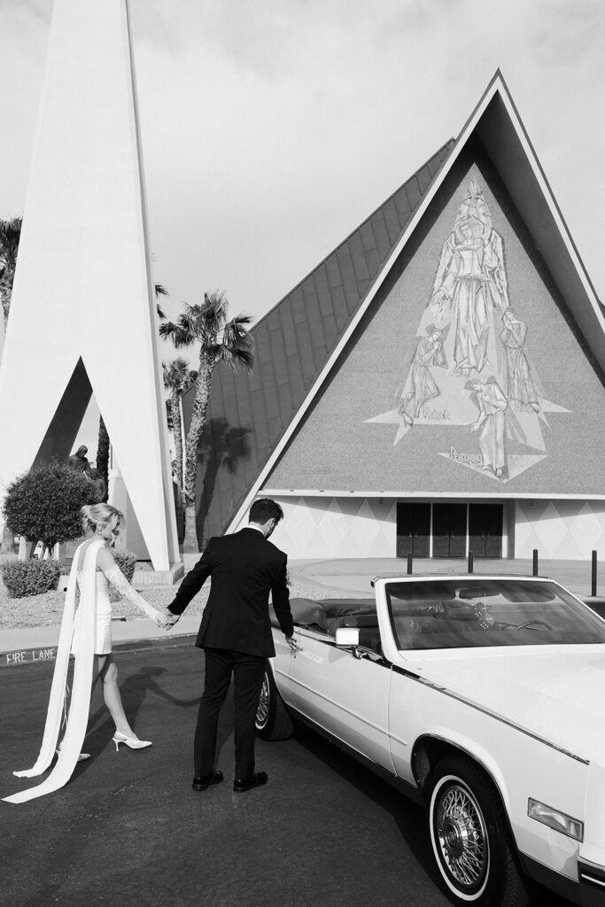 Bride and groom walking toward their Risky Ride outside Guardian Angel Cathedral in Las Vegas.