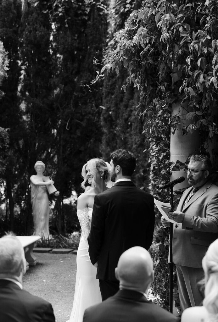 Bride and groom standing together during their ceremony at the Venus Garden Chapel at Caesars Palace.