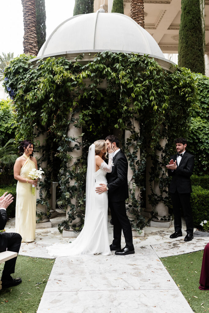 Bride and groom sharing their first kiss at the Venus Garden Chapel at Caesars Palace.