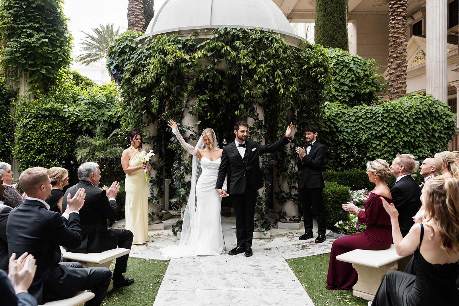 Newly married bride and groom walking down the aisle after their ceremony at the Venus Garden Chapel at Caesars Palace.