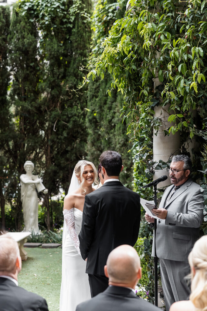 Bride smiling during the wedding ceremony at the Venus Garden Chapel at Caesars Palace in Las Vegas.