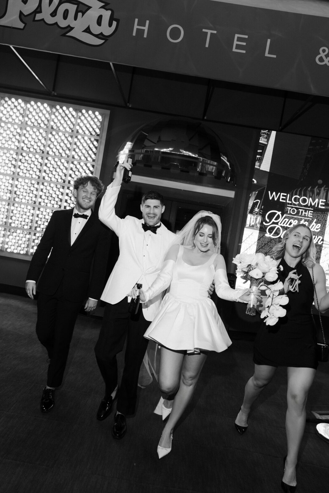 Bride, groom, and friends posing for photos. 