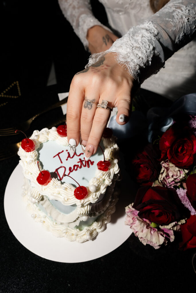 Bride picking off a cherry from her Las Vegas wedding cake.