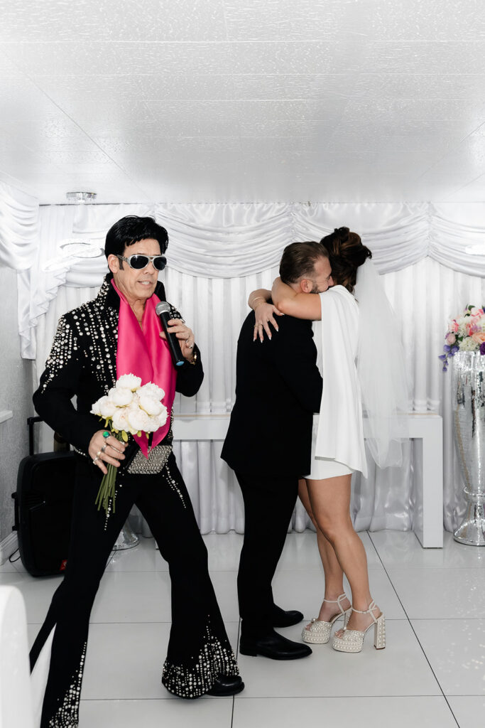 Elvis officiant performing during a fun Las Vegas chapel elopement ceremony.