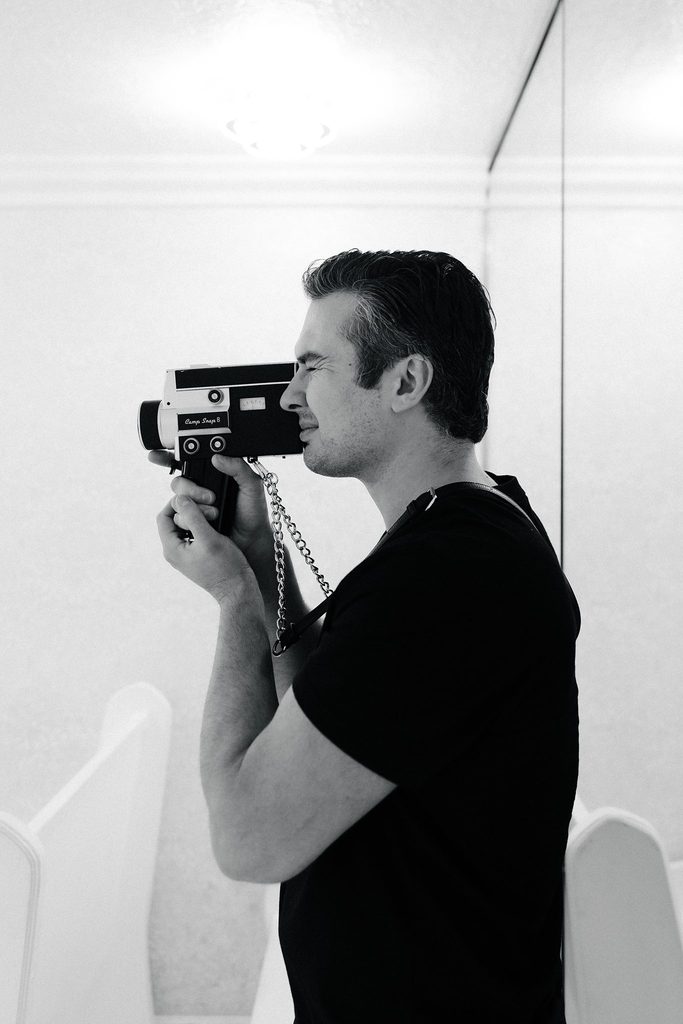 Stephen of Vegas Wedding Content Creator filming with a vintage Super 8 camera in Las Vegas.
