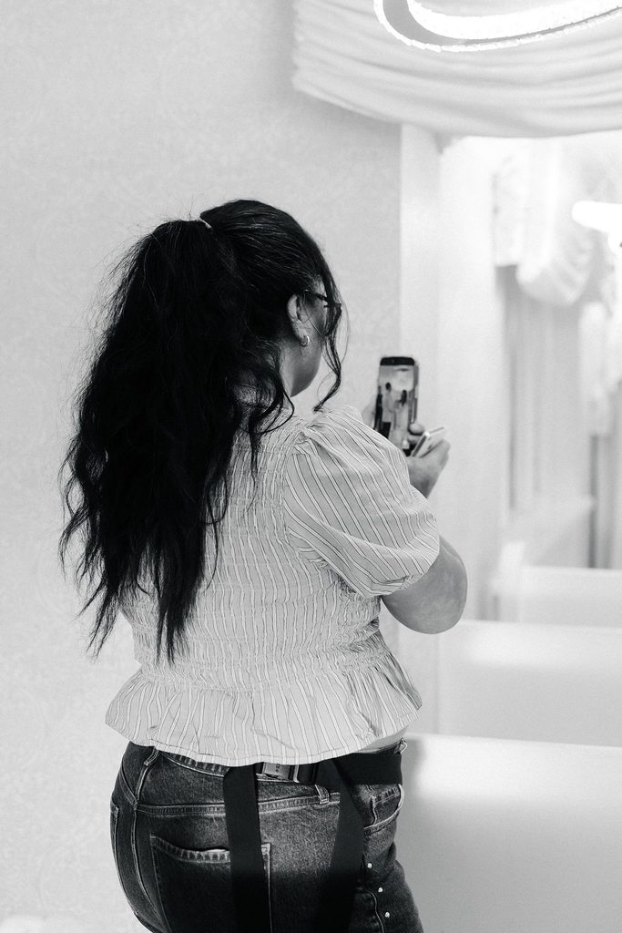 Falon Mei of Vegas Wedding Content Creator capturing wedding content on her phone in Las Vegas.