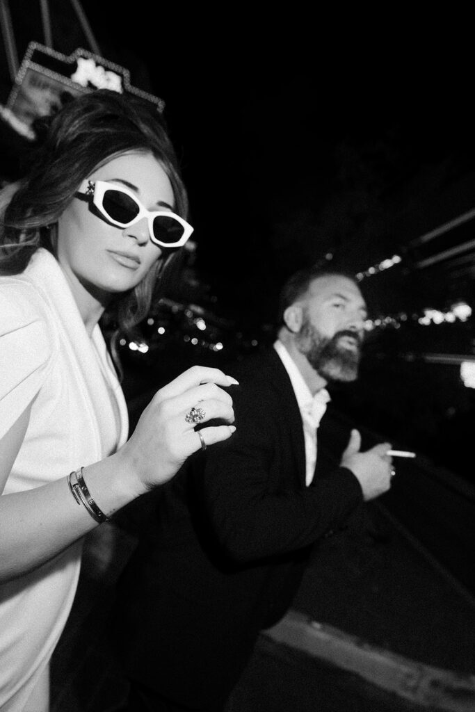 Bride and groom walking together on Fremont Street in downtown Las Vegas.