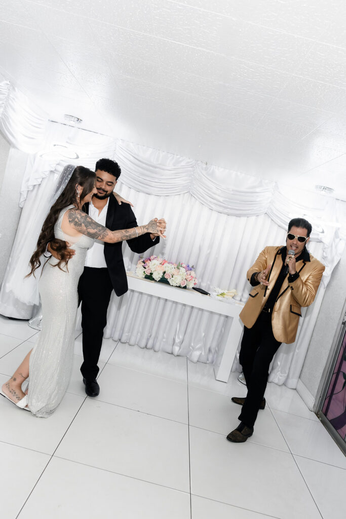 Bride and groom dancing during their Elvis Las Vegas vow renewal at The Little White Wedding Chapel.