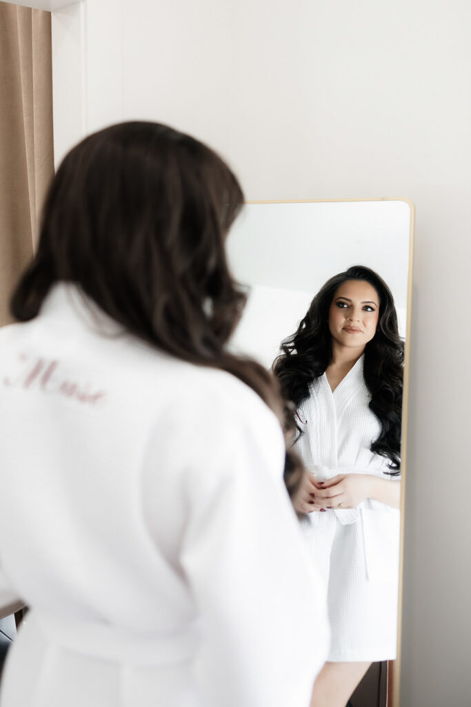 Bride looking at herself in the mirror in one of the getting ready suites at The Lotus House in Las Vegas.