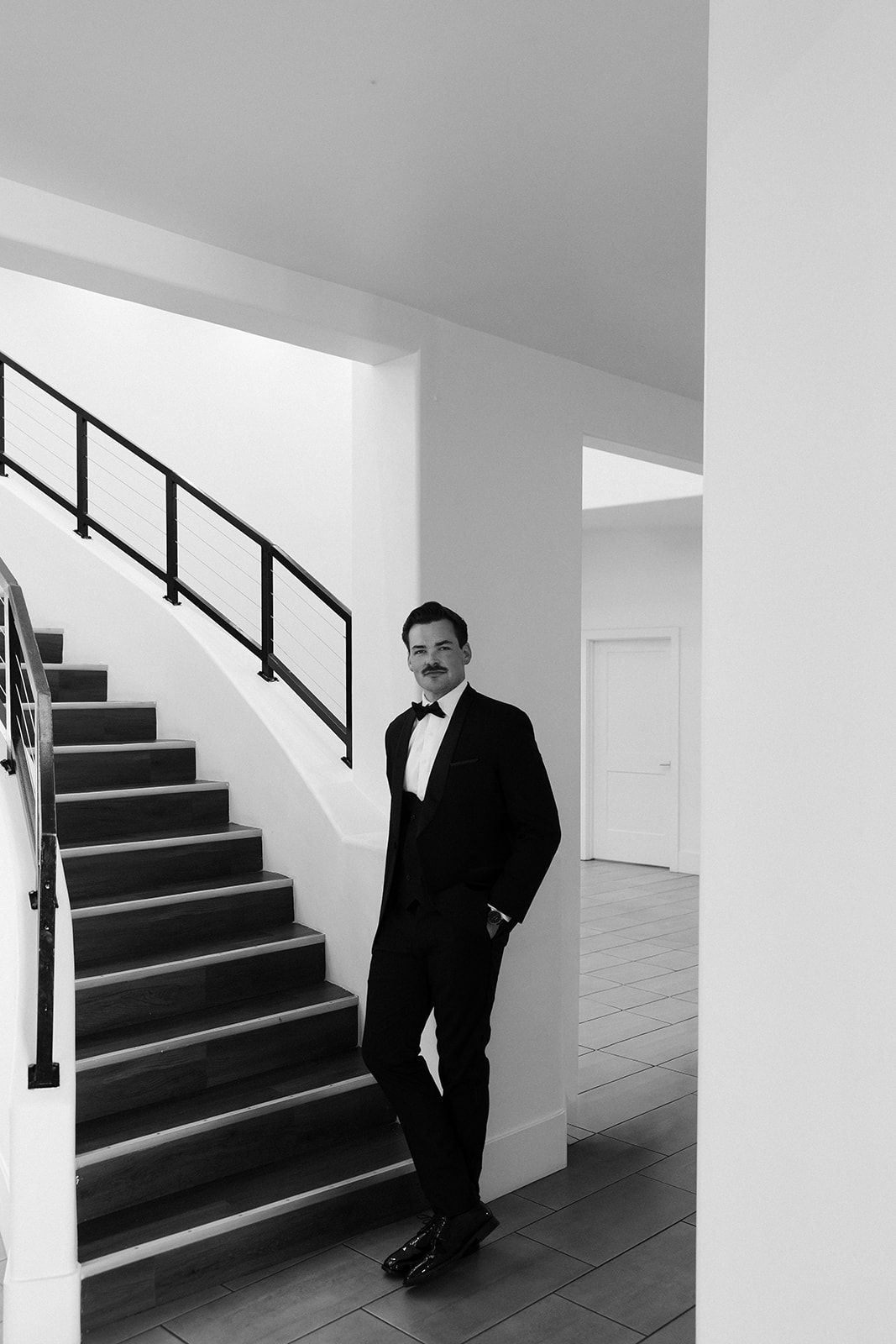 Black and white portrait of a groom posing inside The Lotus House in Las Vegas.
