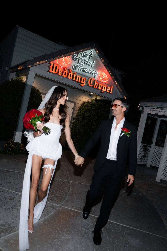 Bride and groom walking in front of A Special Memory Wedding Chapel in Las Vegas.