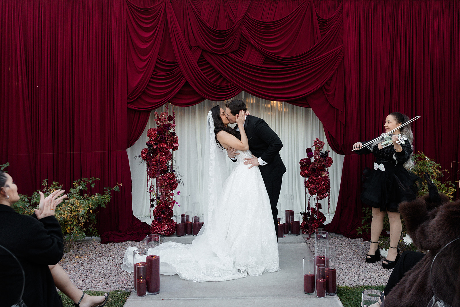 Bride and groom sharing a kiss during their Lotus House wedding ceremony at The Pergola in Las Vegas.