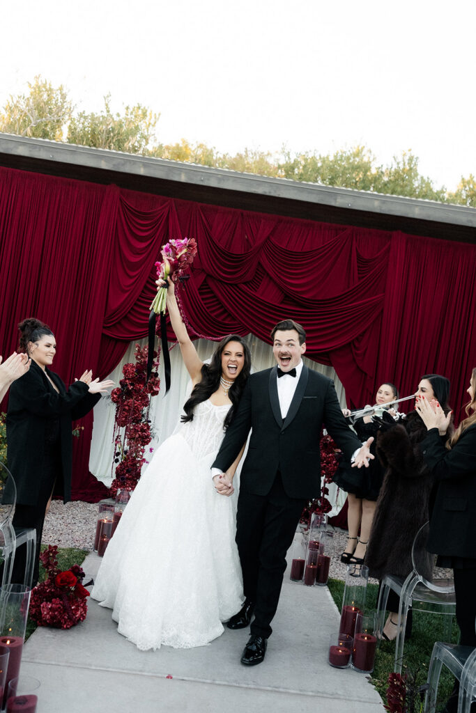 Bride and groom walking back down the aisle as husband and wife during a ceremony at The Lotus House in Las Vegas.