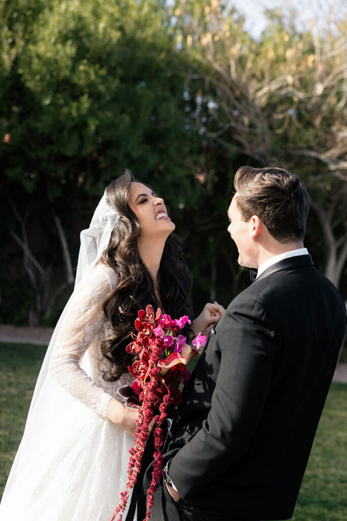 Candid photo of a bride and groom laughing on the lawn at The Lotus House in Las Vegas.