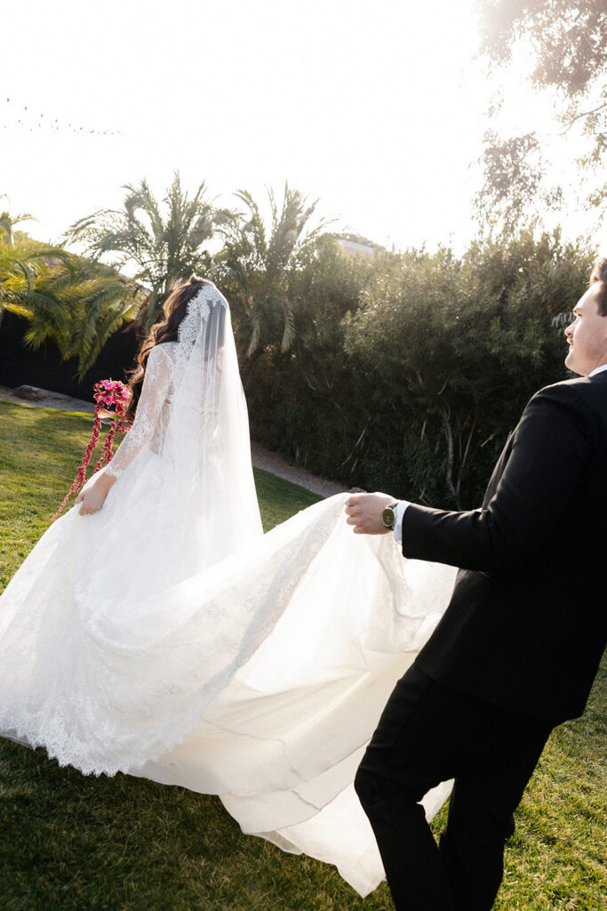 Bride and groom walking on the lawn at The Lotus House in Las Vegas.