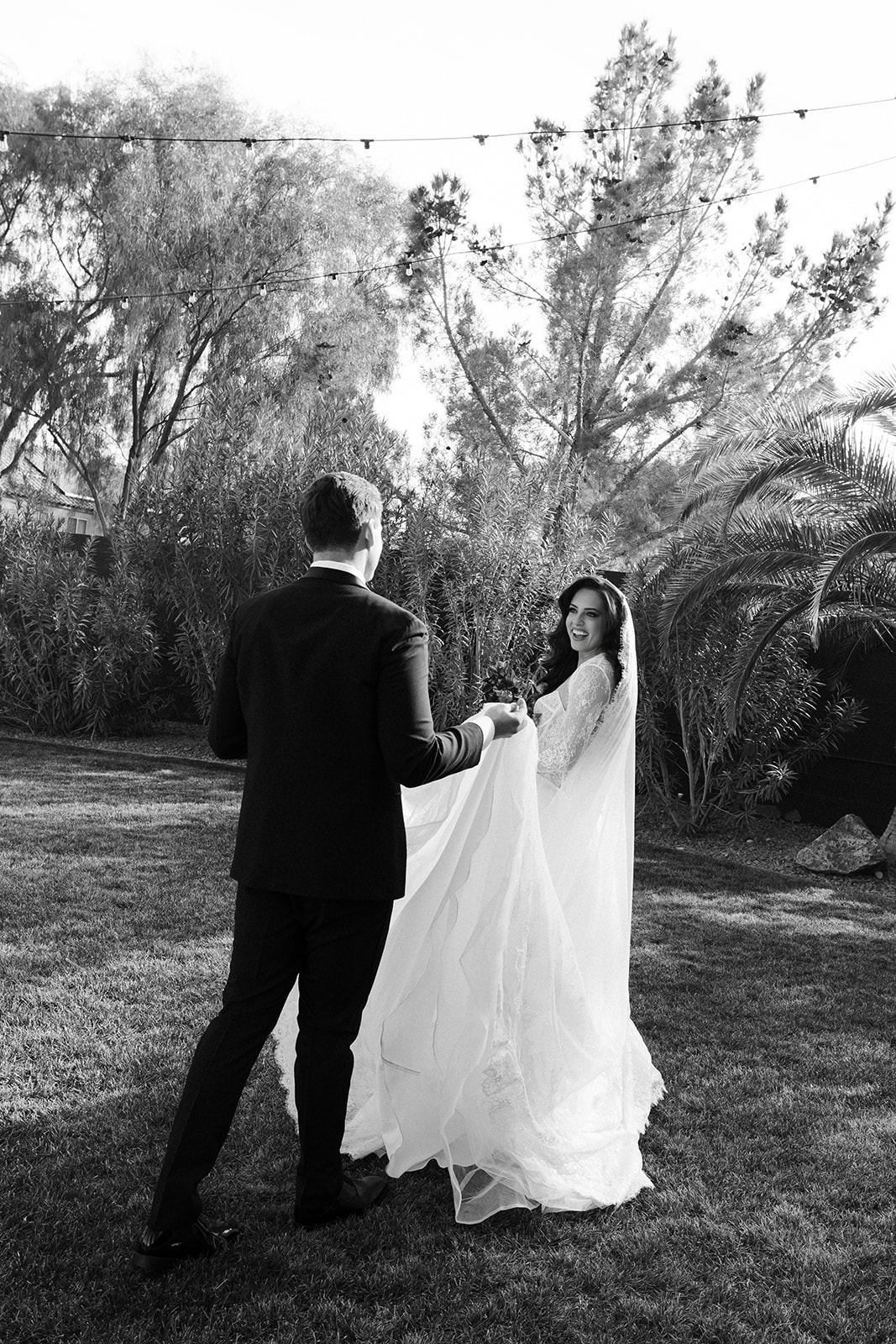 Black and white portrait of a bride and groom outdoors on The Lawn at The Lotus House in Las Vegas.