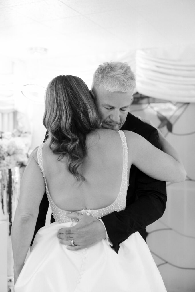 Groom hugging the bride during their emotional vow renewal.