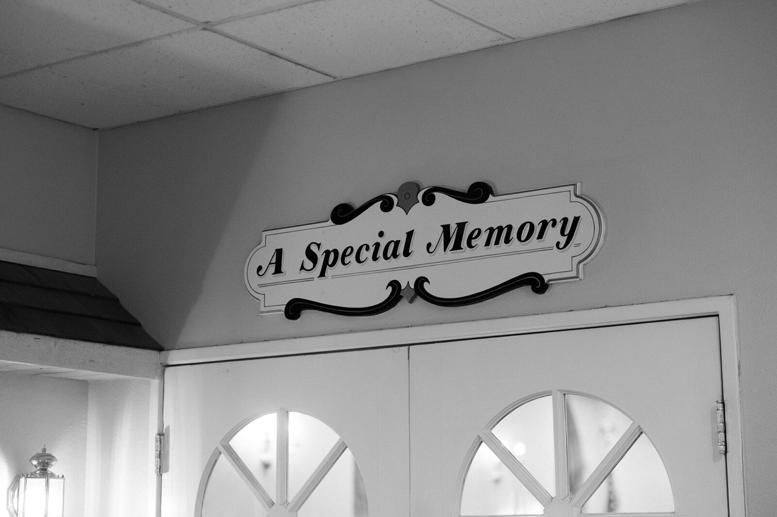 Black and white photo of a sign that says A Special Memory sign over a door at the chapel.