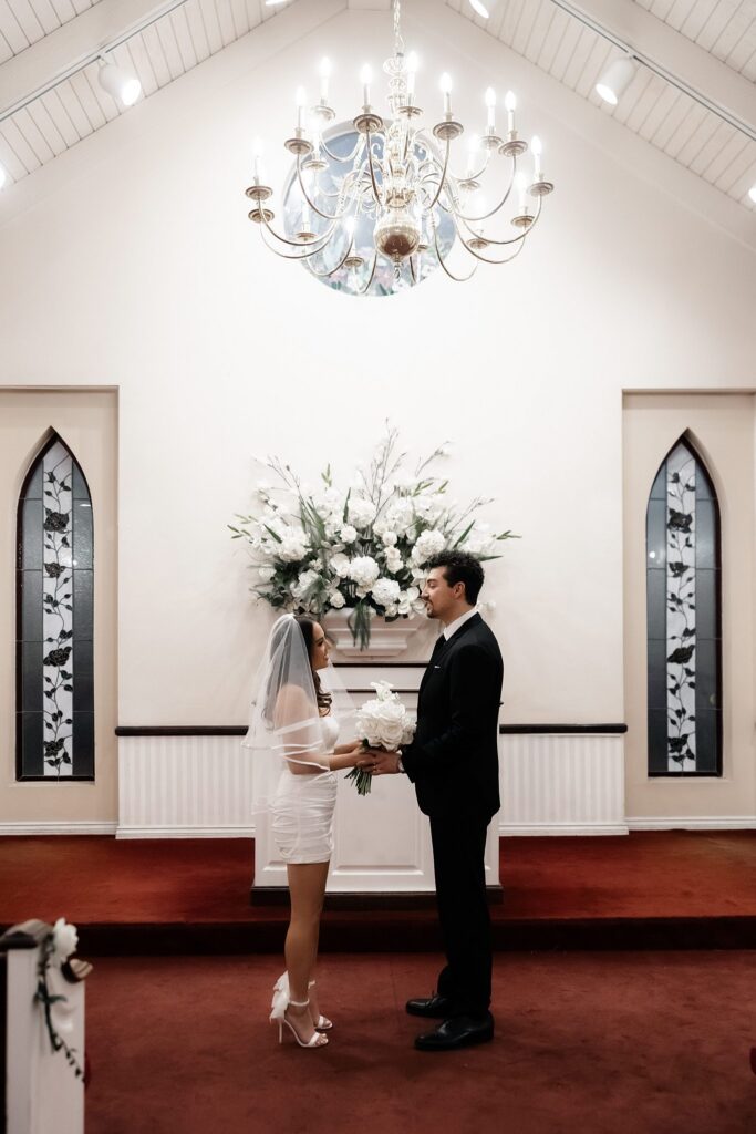 Bride and groom holding hands during their intimate ceremony.