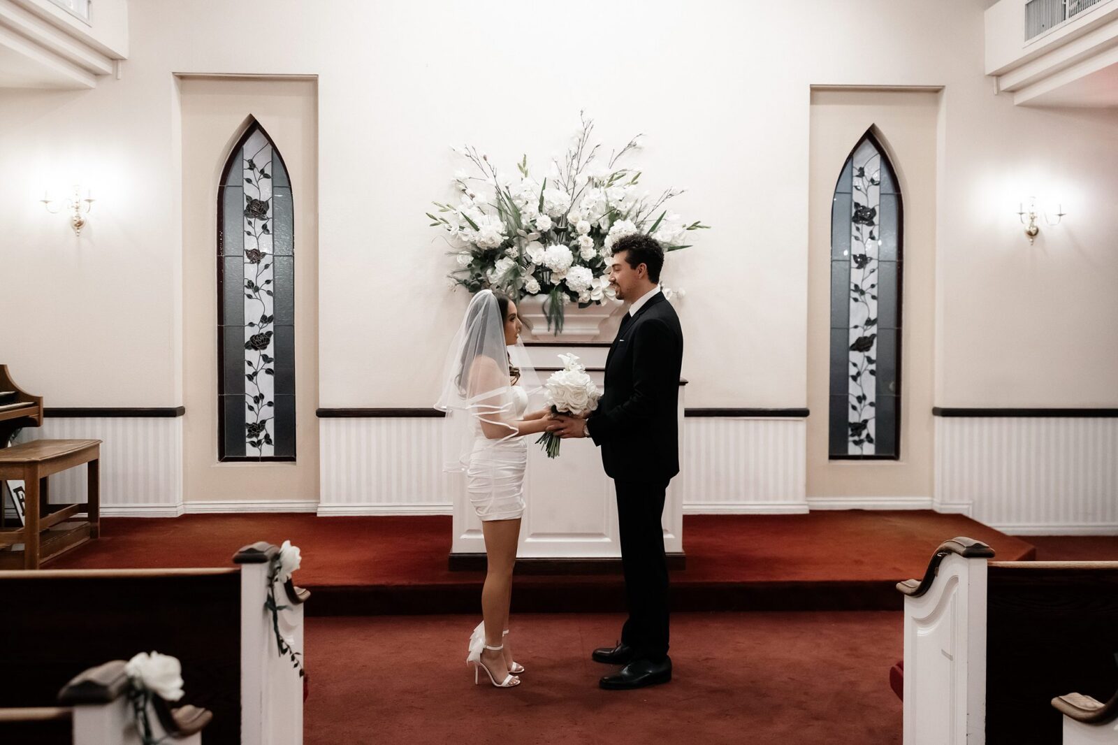 Bride and groom holding hands during their ceremony inside A Special Memory Wedding Chapel in Las Vegas.